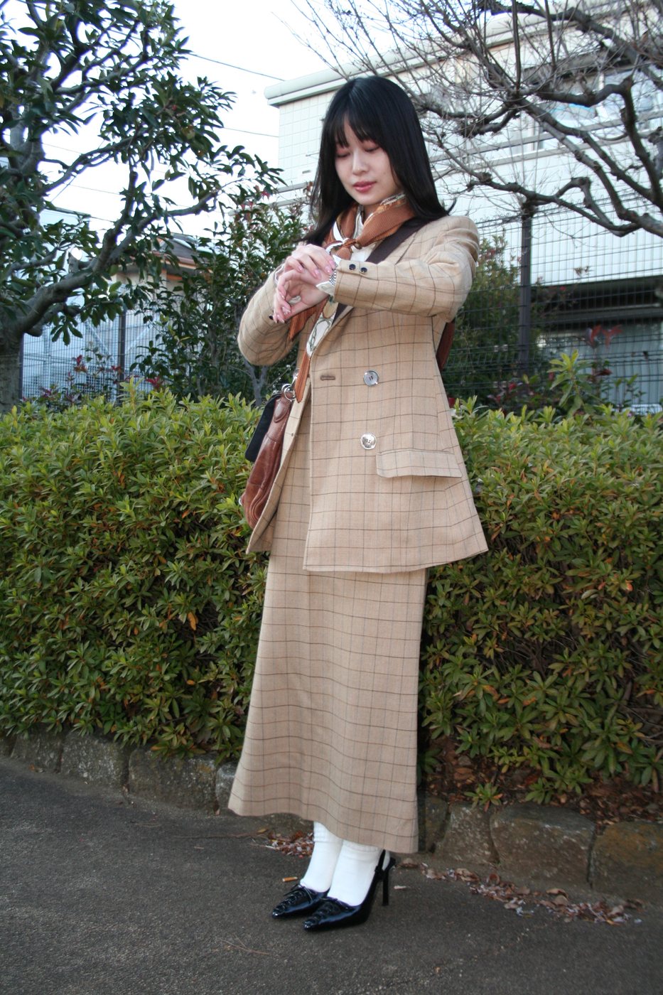 Kersey checker suit worn outdoors, full-length front view of jacket and skirt